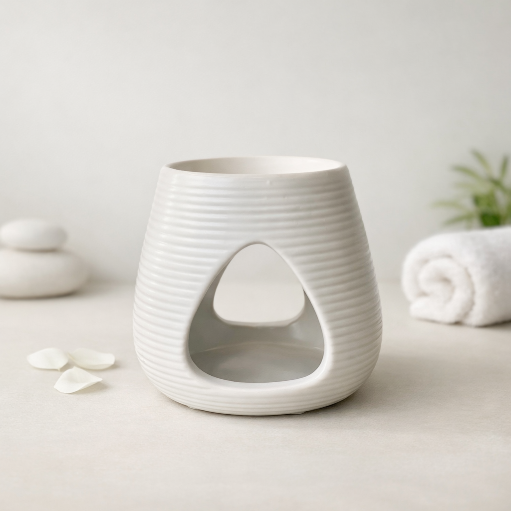 White ceramic wax melt burner with textured surface on a light background